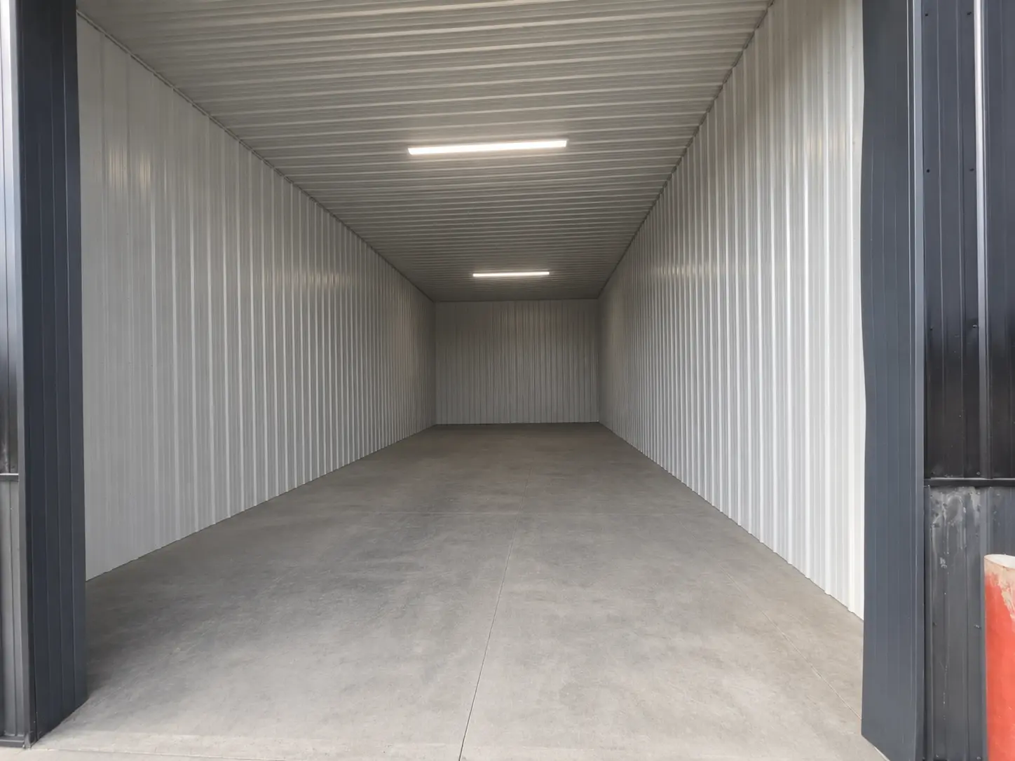 Oversized enclosed storage unit with high ceilings and large overhead door Oversized enclosed storage unit with high ceilings and large overhead door